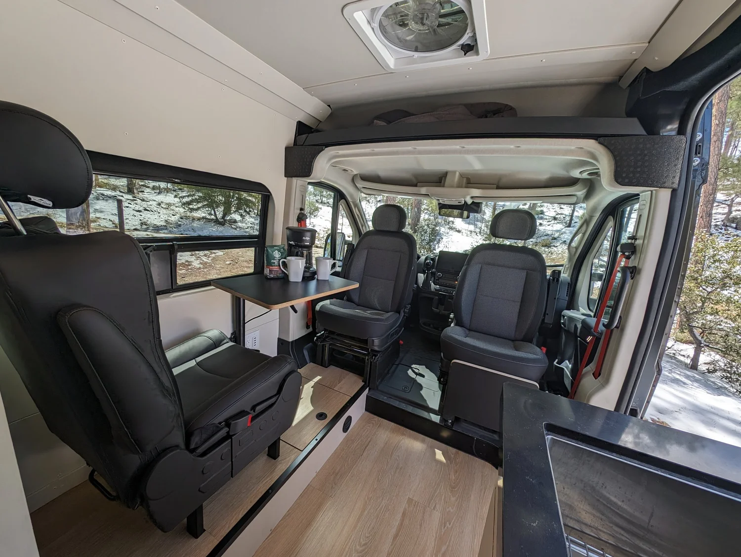 Passenger seating integrates into the living space instead of splitting it in two.
