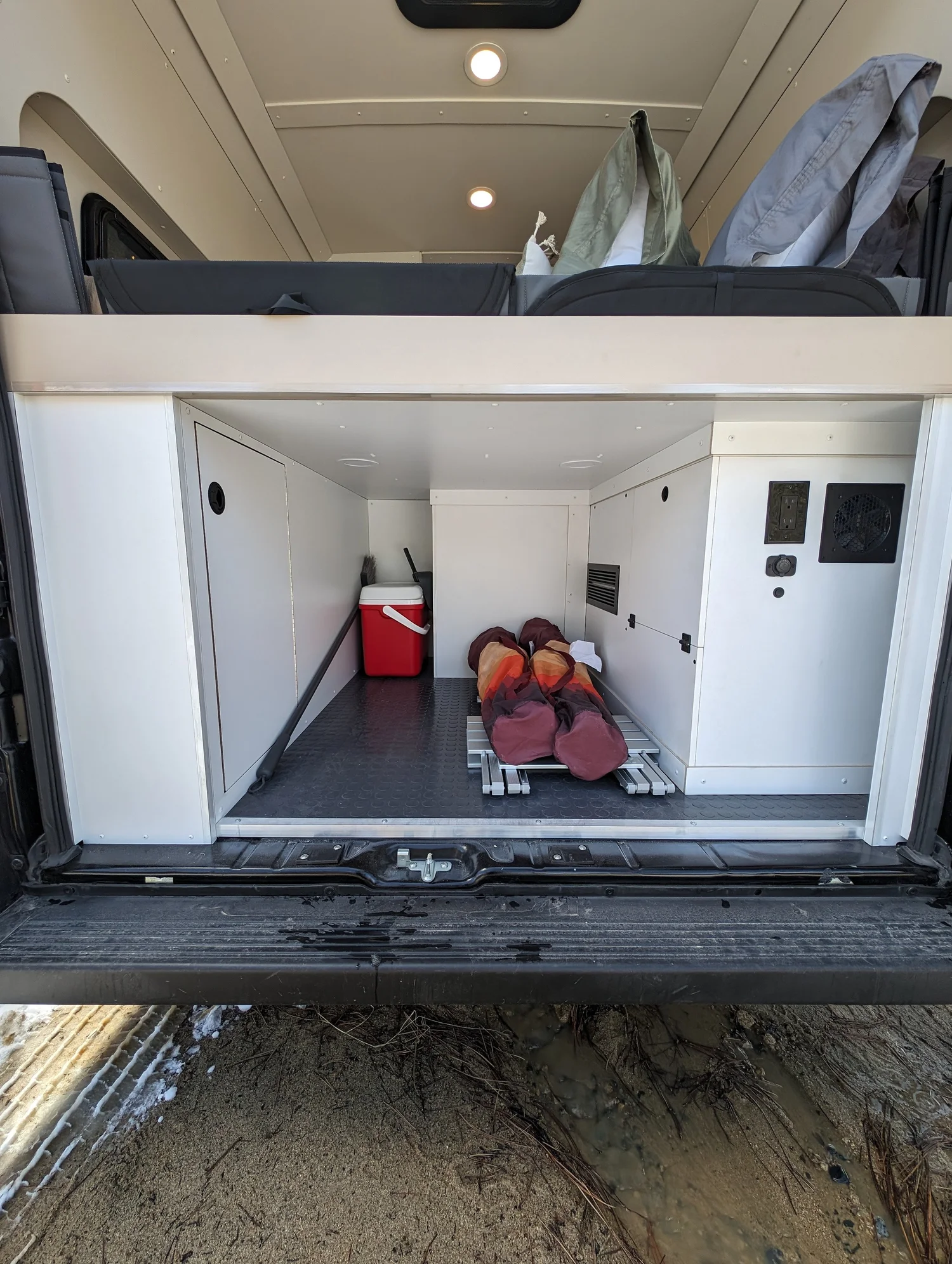 The rear bed and storage read as one clean, continuous composition.