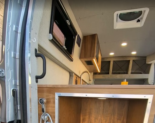 A tall refrigerator uses vertical volume without consuming the aisle.
