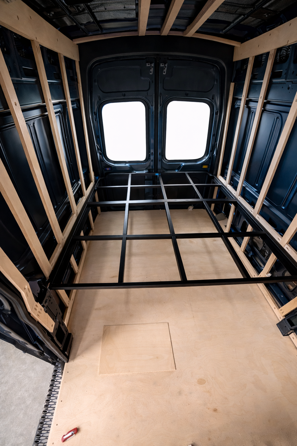 Steel bed frame installed during Frida's conversion