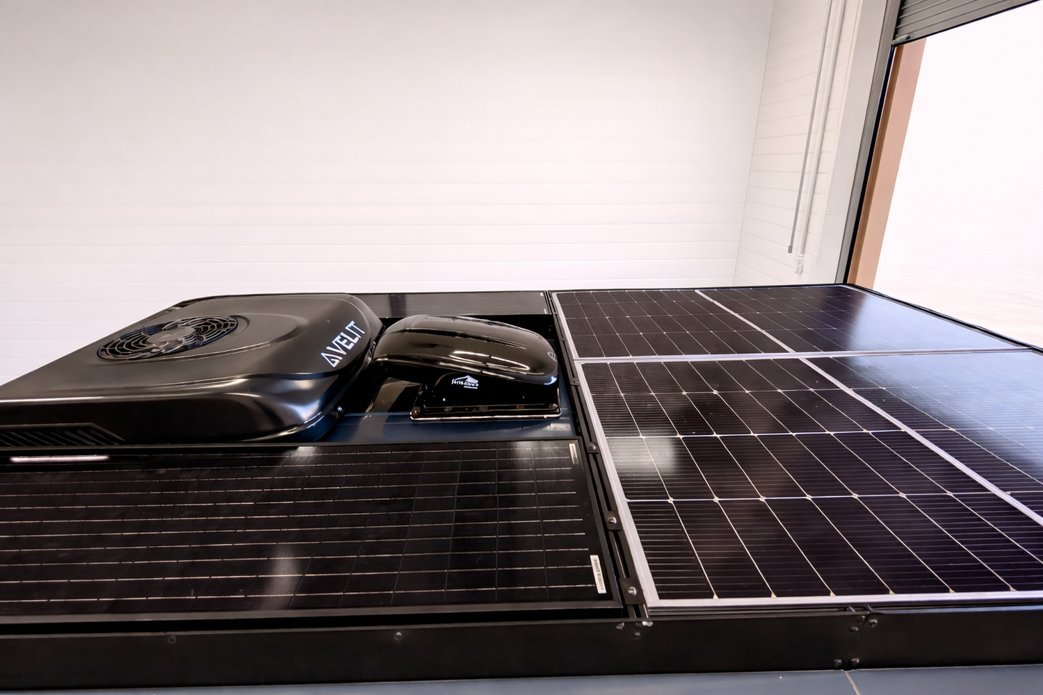 Frida's roof-mounted solar panels, vent and air conditioning system