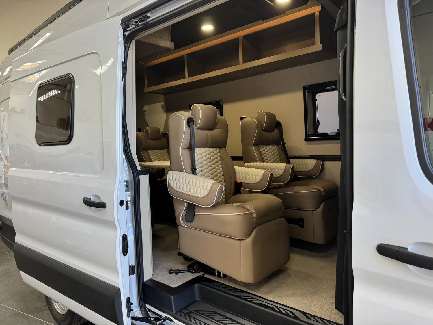 Executive shuttle seating arranged around a central table with warm integrated lighting