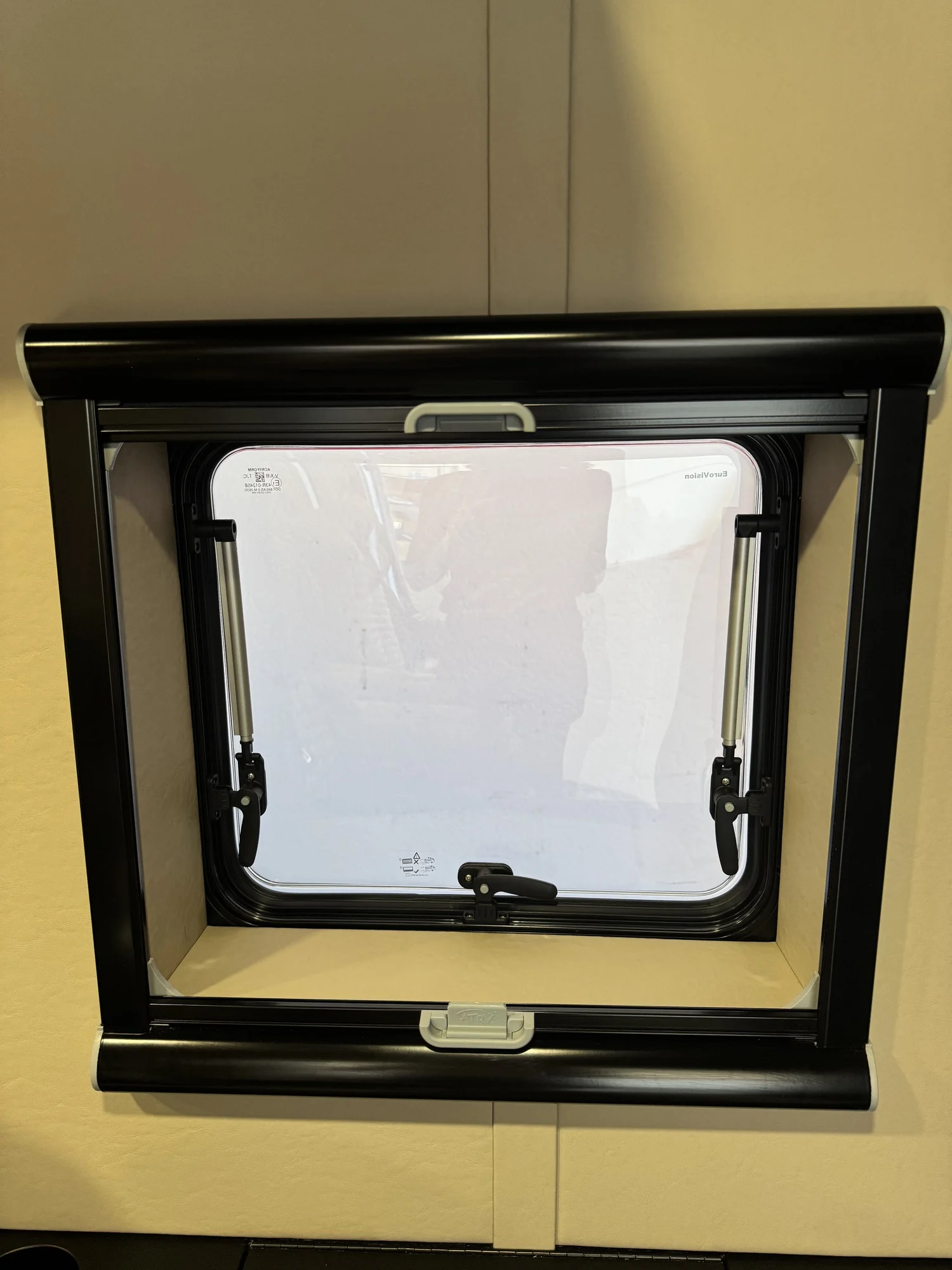 An opening window with its integrated screen and shade in the Transit shuttle.