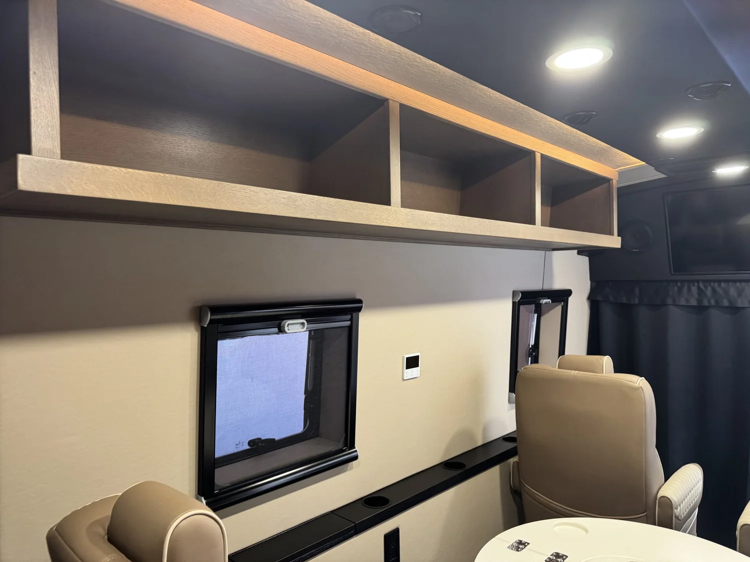 Window shades add privacy and thermal control at each seat.