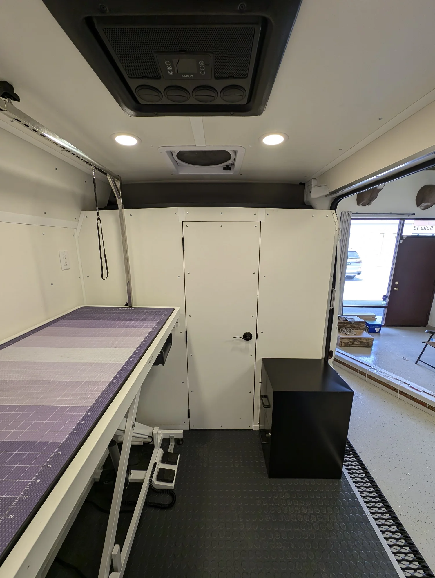 Lighting and ventilation keep the compact salon bright and comfortable.
