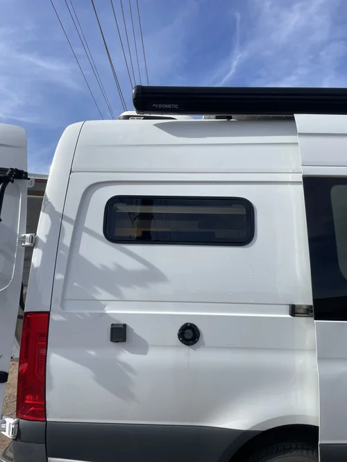 Conversion van window and roof penetrations being inspected